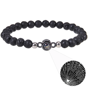 Close-up of projection stone showing I Love You in 100 languages on lava bead bracelet