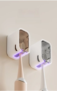 Macro shot of wall-mounted electric toothbrush holder with U-shaped slots and dust cover