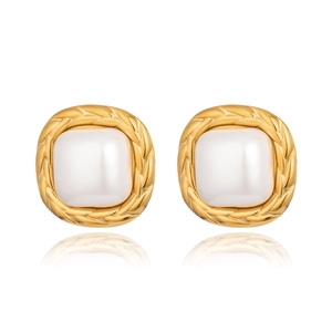 Detail of vintage gold square earrings with white pearl inlay and braided texture