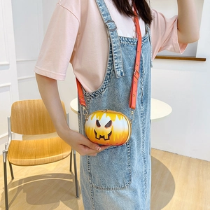 Detailed view of the pumpkin crossbody bag with flame print and adjustable strap