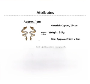 Macro view of gold snake earrings with white zircons showing size dimensions and materials