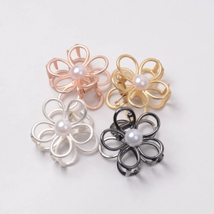 Close-up of pearl flower hair clips in rose gold, gold, silver, and gunmetal finishes