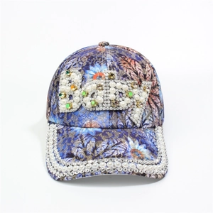 Detailed macro of crystal rhinestones and pearls forming BODY text on floral baseball cap