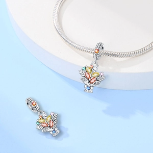 Close-up of bouquet charm with colorful zircon stones on a silver plated bracelet