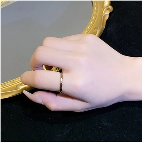 Detail of rose gold titanium geometric faceted ring worn on a finger for a minimalist look