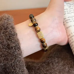 Tiger eye beaded bracelet with hollow gourd jade pendant on model wearing knit sweater