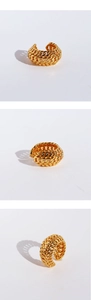 Macro detail of gold-plated hollow chain link texture on an adjustable metal ear cuff