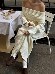 Detailed texture of white ribbed knit fabric on an off-shoulder long sleeve dress