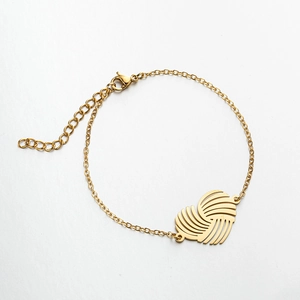 Detailed view of gold stainless steel bracelet with geometric hollow heart charm