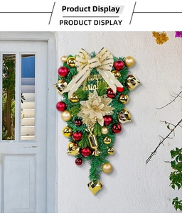 Close-up of a Christmas teardrop swag with red and gold ornaments and Merry Christmas sign