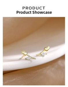 Macro shot of 925 silver golden tulip stud earrings featuring a sparkling zircon leaf detail