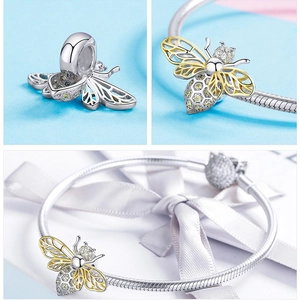 Detailed macro view of honey bee charm with zircons on a silver snake chain bracelet