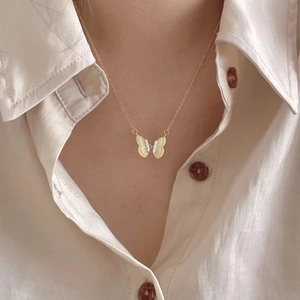 Minimalist 925 sterling silver butterfly necklace with white zircon on a female model