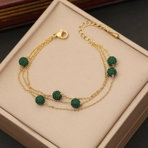 Bracciale multistrato in acciaio dorato con sei sfere pavé di cristalli verdi brillanti