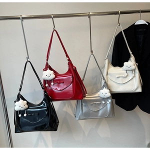 Detailed row of glossy tote bags with bow accents and fluffy cloud charms on hangers