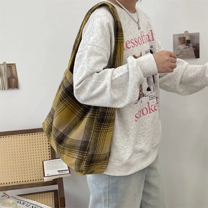 Detail of wool blend plaid tote bag in yellow and brown checkers with wide shoulder strap