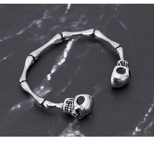 Macro view of gothic silver stainless steel skeleton bracelet with skull head details