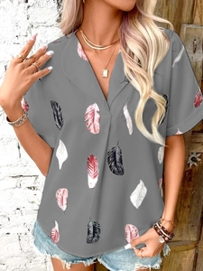 Close-up of summer grey V-neck blouse with colorful feather print pattern and short sleeves