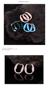 Detail of colorful enamel hoop earrings in pink green and blue with S925 silver hallmark