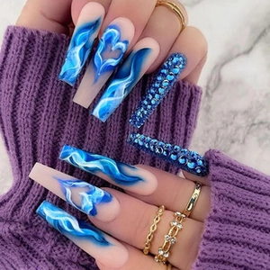 Detailed view of long square press-on nails with blue flame hearts and crystal rhinestone