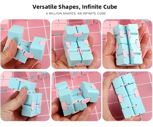 Macro view showing the 2x2 infinity cube in pink and blue colors being flipped by hand