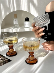 Close-up of vintage ribbed wine glasses with elegant ball-shaped stems in natural light