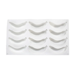 Detailed top view of a white silicone mold with 12 banana-shaped cavities for baking