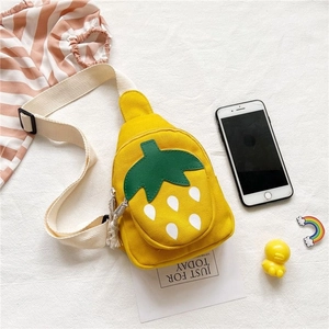Detail of yellow strawberry canvas crossbody bag for kids with white strap and black buckle