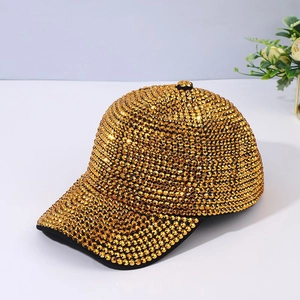Close-up detail of luxury gold baseball cap with sparkling rhinestones and metal studs