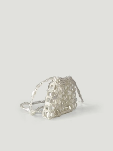 Detail of silver sequin beaded handbag with geometric hollow structure and shiny finish