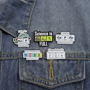 5pcs science enamel pin set with periodic table elements on denim fabric background