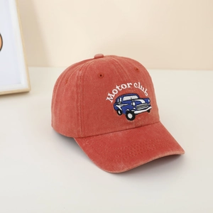 Detail of vintage orange kids baseball cap featuring blue car embroidery and Motor Club text