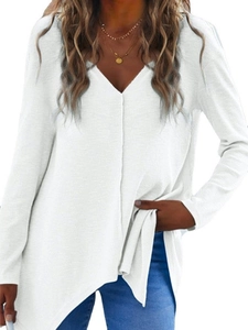 Detail of white waffle knit V-neck top featuring loose fit and asymmetric hem style