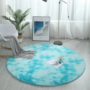 Detail of round blue tie-dye plush rug featuring soft long pile and modern nordic style