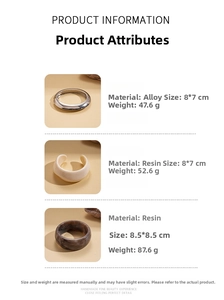 Detailed view of resin and metal chunky bangles with marble texture and polished finish