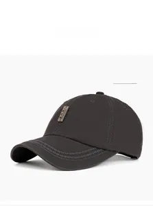 Detail view of washed grey cotton baseball cap with wave stitching and metal plate