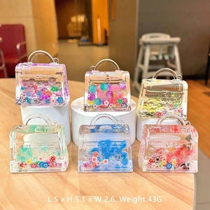 Detailed view of 5x5cm acrylic mini bag pendants with colorful beads and floral sequins