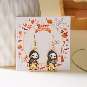 Detail of Halloween skull earrings with oil-painted flower motifs on display card