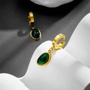 Detailed view of elegant gold-plated stainless steel earrings with oval green gemstone drops