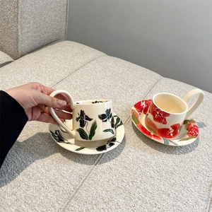 Vintage iris ceramic coffee cup and saucer set featuring red and black floral patterns