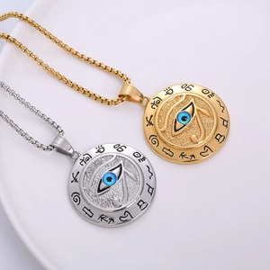 Gold and silver Eye of Horus stainless steel pendant necklaces on a white ceramic plate