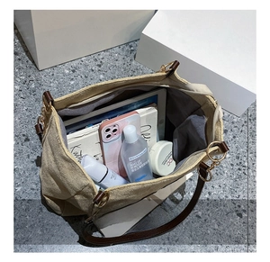 Spacious canvas tote interior showing organization of books, tablet and cosmetics