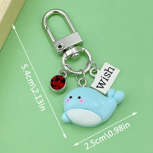 Blue resin whale dolphin keychain with red gem and Wish tag measured at 5.4cm in length