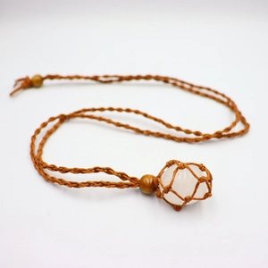 Detail of hand-woven brown cord pouch with polished white crystal and wooden beads