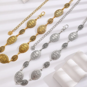 Detailed view of silver and gold alloy waist chains with vintage embossed patterns