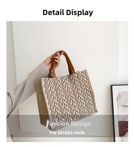Detailed shot of striped woven tote bag with brown handles and geometric patterns