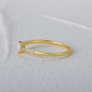 Macro side view of an S925 silver ring with 18K gold finish, opal and side diamonds