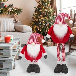 Standing Christmas gnomes with retractable legs in a festive living room setting