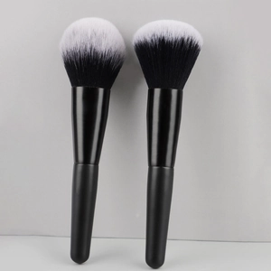 Close-up of dual-tone synthetic bristles on two professional matte black makeup brushes