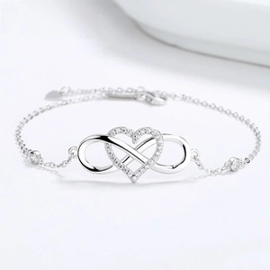Detail of S925 sterling silver infinity heart bracelet with sparkling cubic zirconia accents
